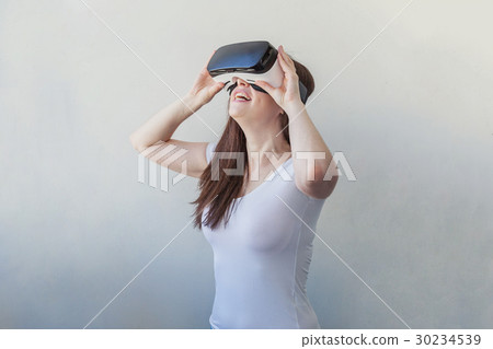 Woman using VR headset Woman using VR headset 30234539