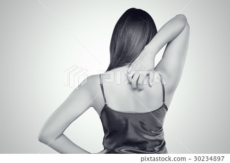Woman scratching her itchy back with allergy rash Woman scratching her itchy back with allergy rash 30234897