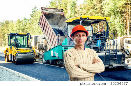 Workman with asphalt-placing machine Workman with asphalt-placing machine 30234977