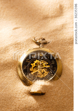 Pocket watch in beach sand 30235396