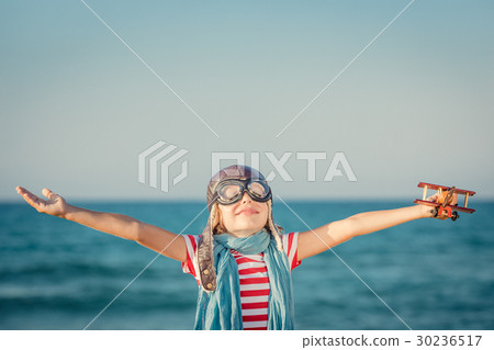 Happy child playing with toy airplane 30236517