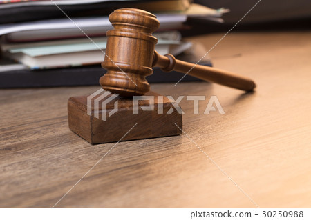 Photo of hammer against documents 30250988