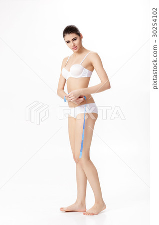 beautiful brunette woman measuring her perfect beautiful brunette woman measuring her perfect 30254102