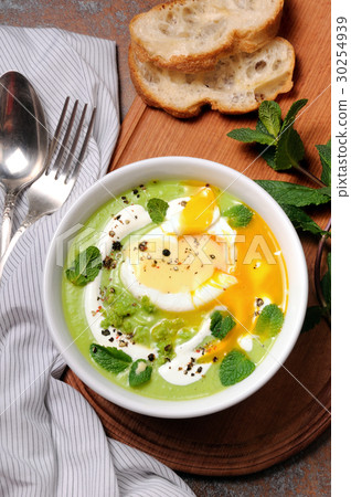 Pea puree soup with poached egg and peppermint Pea puree soup with poached egg and peppermint 30254939