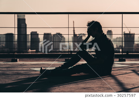 Depressed man lost hope and cry, sit on rooftop 30257597