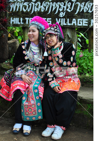 The tourists wear tribal costumes of Miao Tribal The tourists wear tribal costumes of Miao Tribal 30257693