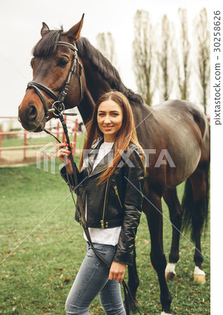 Beautiful girl communicates with a horse in the Beautiful girl communicates with a horse in the 30258626