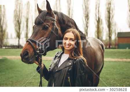Beautiful girl communicates with a horse in the Beautiful girl communicates with a horse in the 30258628