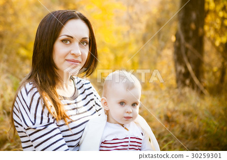 Mother with her baby daughter in autumn park Mother with her baby daughter in autumn park 30259301