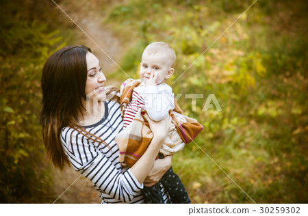Mother with her baby daughter in autumn park Mother with her baby daughter in autumn park 30259302