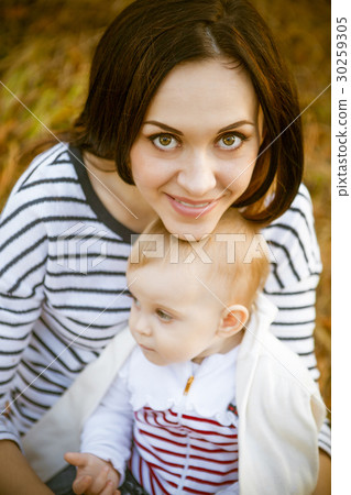 Mother with her baby daughter in autumn park Mother with her baby daughter in autumn park 30259305