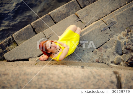 Portrait of the beautiful woman in a yellow dress on the embankment in Sankt Petersburg at sunset Portrait of the beautiful woman in a yellow dress on the embankment in Sankt Petersburg at sunset 30259779