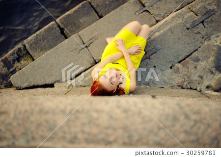 Portrait of the beautiful woman in a yellow dress on the embankment in Sankt Petersburg at sunset Portrait of the beautiful woman in a yellow dress on the embankment in Sankt Petersburg at sunset 30259781
