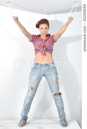 Young beautiful woman stay and plays the fool at the time of repair Young beautiful woman stay and plays the fool at the time of repair 30260089