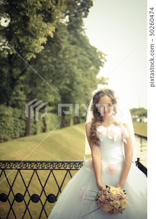 Portrait of beautiful bride in a park Portrait of beautiful bride in a park 30260474