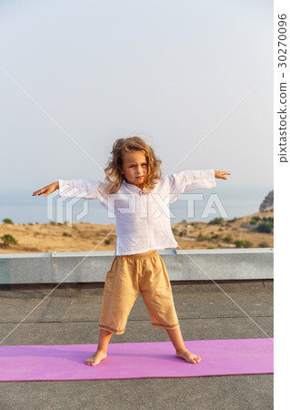 Baby doing yoga on the roof 30270096