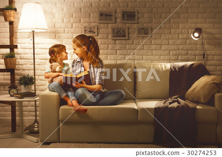 Family before going to bed mother reads to her child daughter bo 30274253