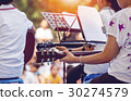 Close up of young girl is playing the guitar 30274579