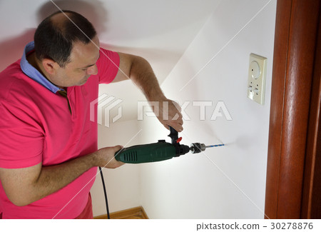 Man Drilling a Hole Man Drilling a Hole 30278876