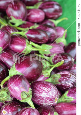 Fresh eggplants for sale in a market Fresh eggplants for sale in a market 30281079