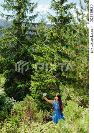 woman travel forest with smartphone 30286929