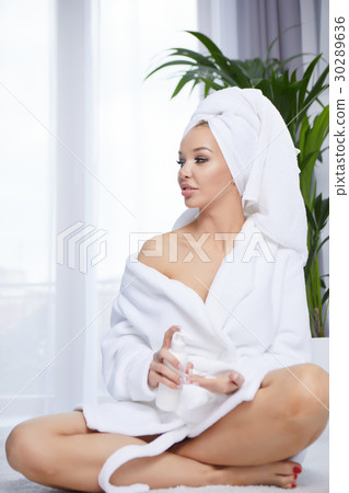 beautiful young woman wearing a towel and a white bathrobe and a beautiful young woman wearing a towel and a white bathrobe and a 30289636