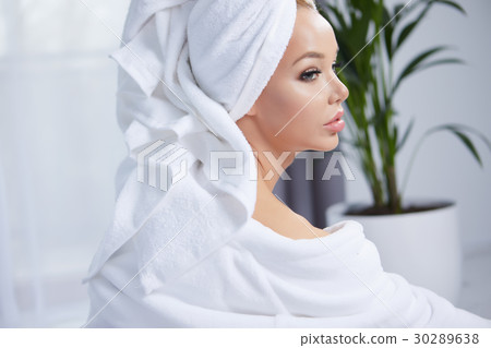 beautiful young woman wearing a towel and a white bathrobe and a beautiful young woman wearing a towel and a white bathrobe and a 30289638