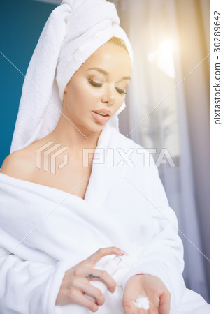beautiful young woman wearing a towel and a white bathrobe and a beautiful young woman wearing a towel and a white bathrobe and a 30289642