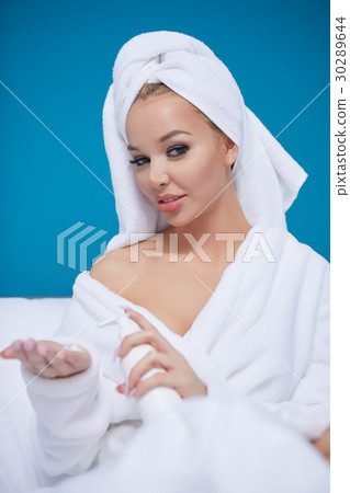 beautiful young woman wearing a towel and a white bathrobe and a beautiful young woman wearing a towel and a white bathrobe and a 30289644