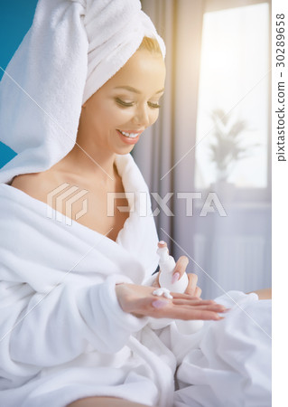 beautiful young woman wearing a towel and a white bathrobe and a beautiful young woman wearing a towel and a white bathrobe and a 30289658