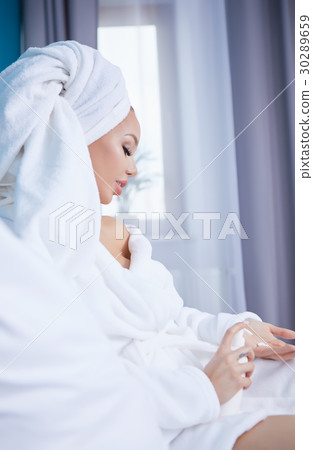 beautiful young woman wearing a towel and a white beautiful young woman wearing a towel and a white 30289659