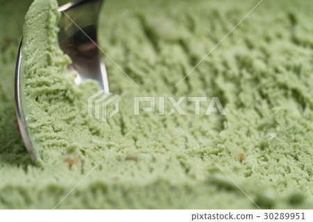 scooping natural pistachio ice cream with spoon 30289951