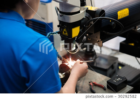 Worker welding repair mold and die part by Laser  30292582