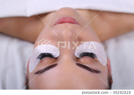 Eyelash Extension Procedure. Woman Eye with Long 30292828