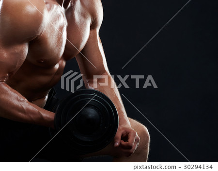 Muscular young man lifting weights on black 30294134