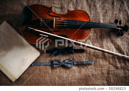 Violin, fiddlestick, notes and bowties closeup Violin, fiddlestick, notes and bowties closeup 30298823
