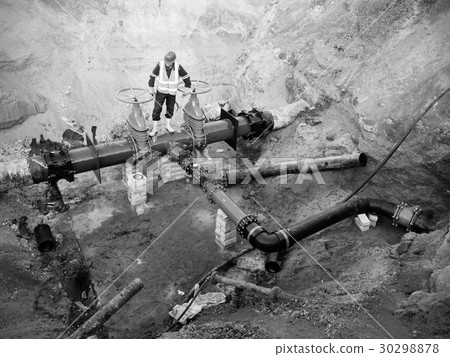 Worker underground at  gate valve on water system 30298878