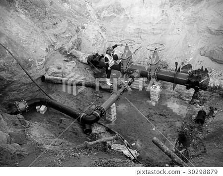 Worker underground at drink water system pipeline Worker underground at drink water system pipeline 30298879