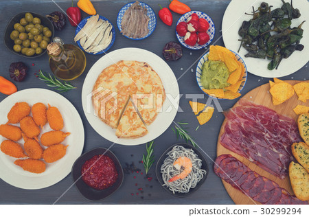 Table with spanish tapas 30299294