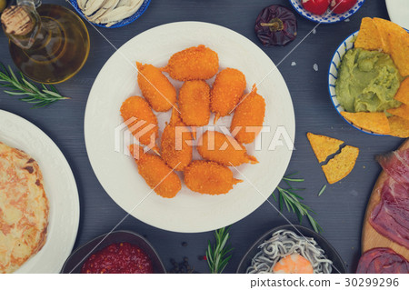Table with spanish tapas 30299296