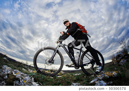 Photo below of the mountain cyclist in the black Photo below of the mountain cyclist in the black 30300378