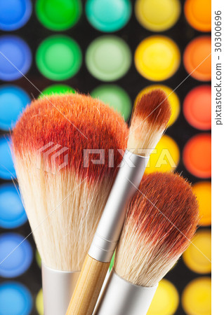 makeup brushes and set of colorful eye shadows 30300696