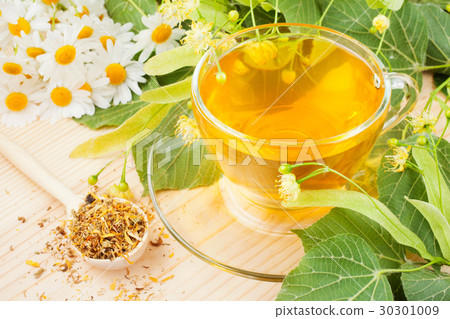 linden and chamomile flowers and healthy tea cup 30301009
