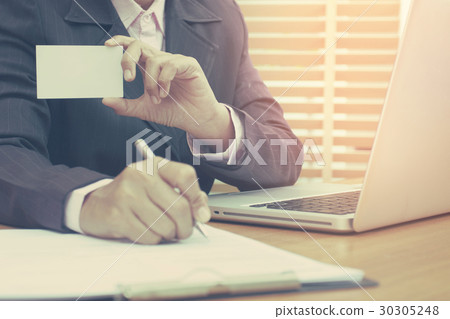 Business woman holding white blank business card . Business woman holding white blank business card . 30305248