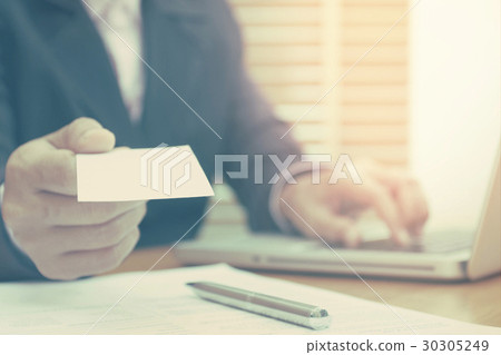 Business woman holding white blank business card. Business woman holding white blank business card. 30305249