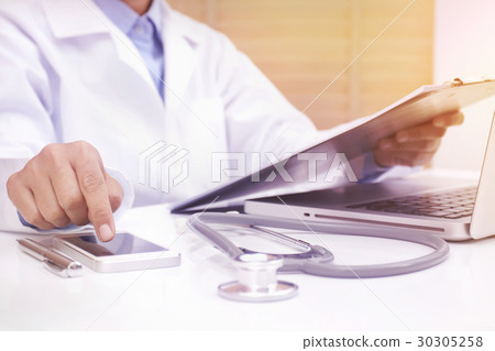 Woman doctor using mobile smart phone. Woman doctor using mobile smart phone. 30305258