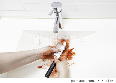 Wiping blood from a knife 30307156