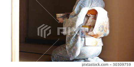 A woman enjoying a tea ceremony A woman enjoying a tea ceremony 30309759