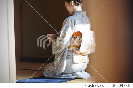 A woman enjoying a tea ceremony A woman enjoying a tea ceremony 30309788