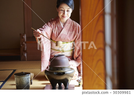 A woman enjoying a tea ceremony A woman enjoying a tea ceremony 30309981